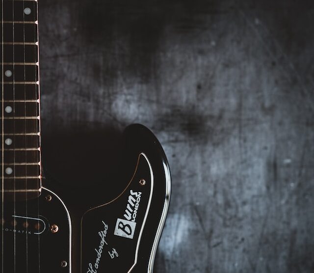 black electric guitar on a dark background